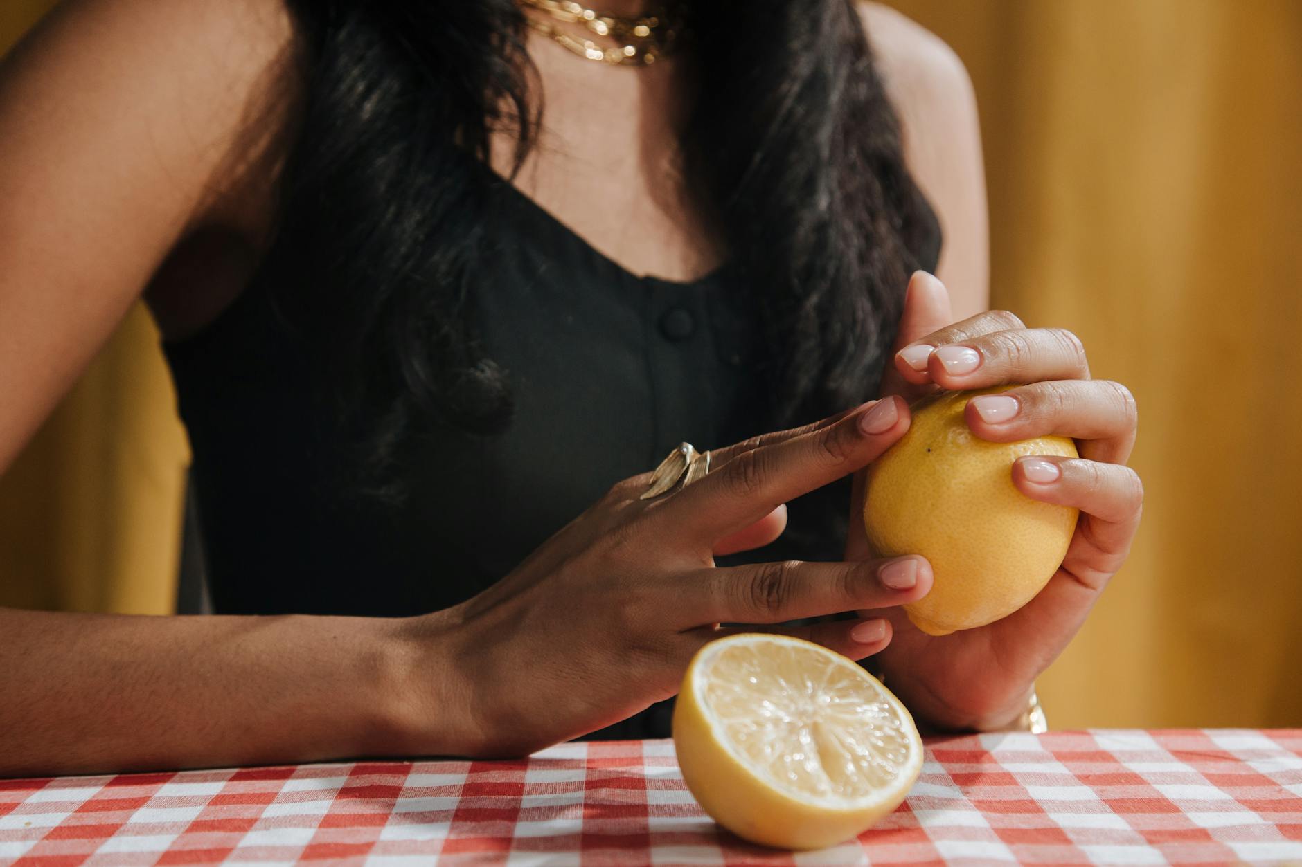 Woman holding blue and pink silicone vibrators in contemplative pose